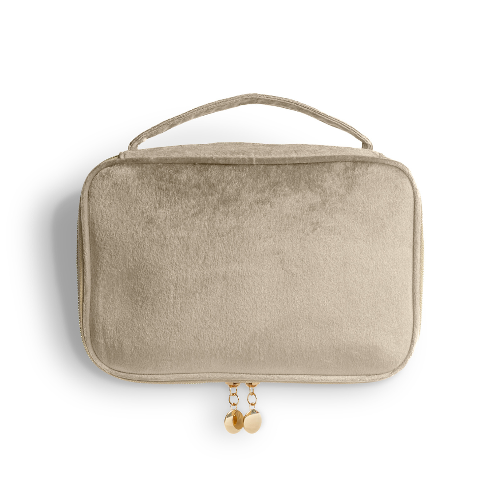 Beige travel pouch with a handle and gold zipper on a white background