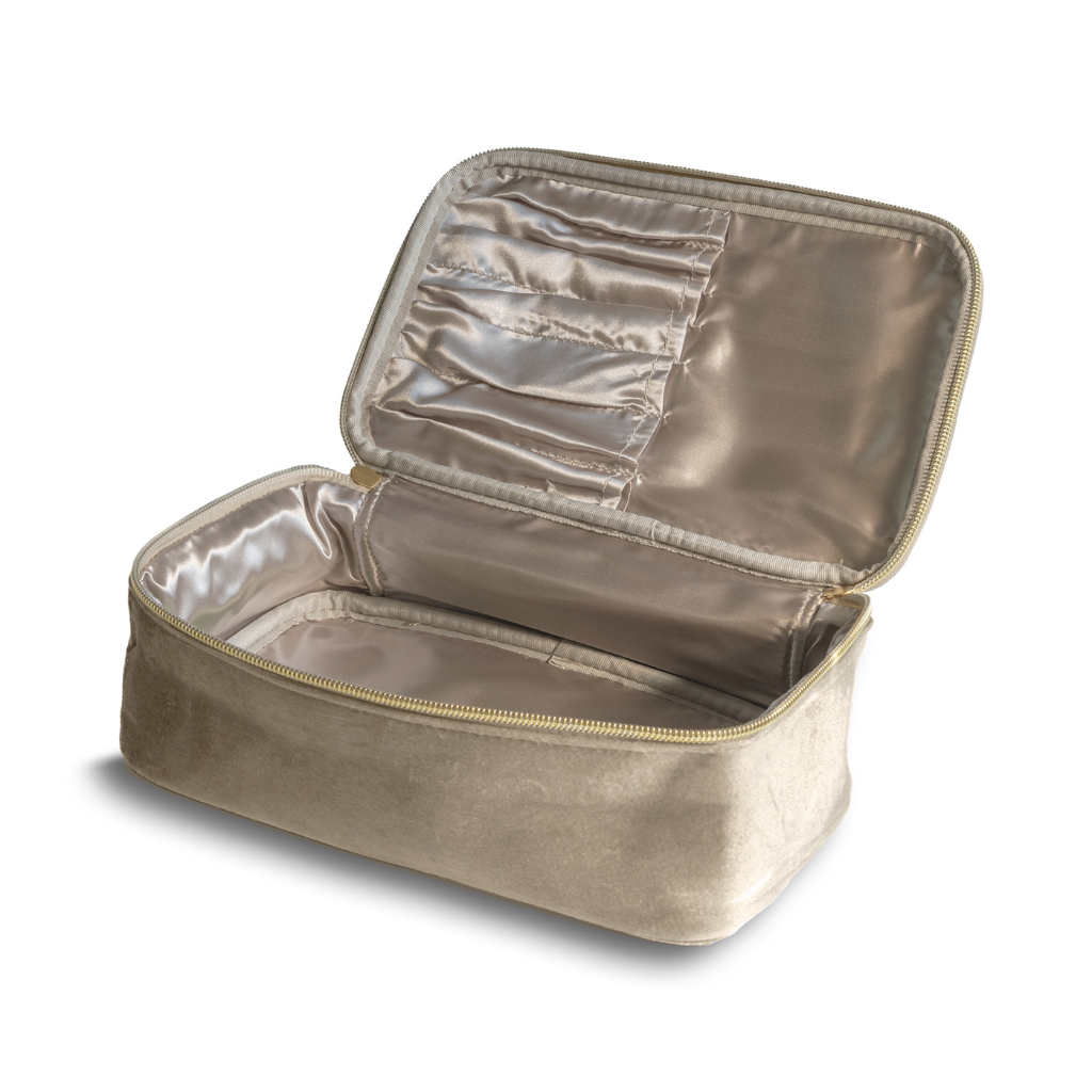 Gold toiletry bag with open top compartment on a white background