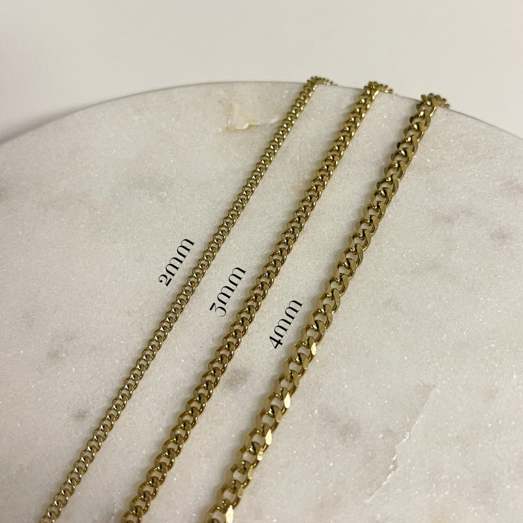 2mm, 3mm and 4mm width cuban chains laid next to eachother to show size difference 