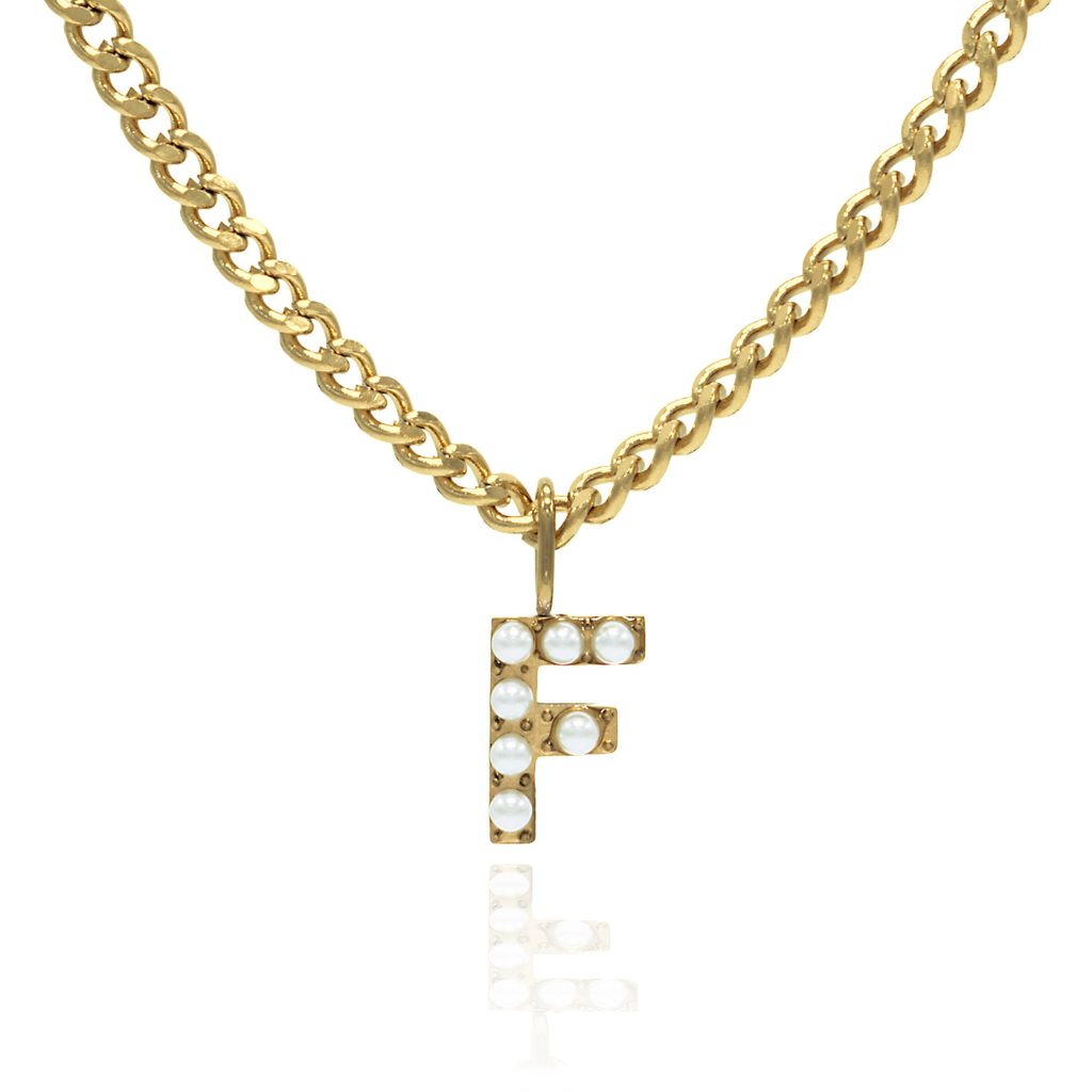 A gold-colored necklace with a pearl initial charm attached to a curb chain.