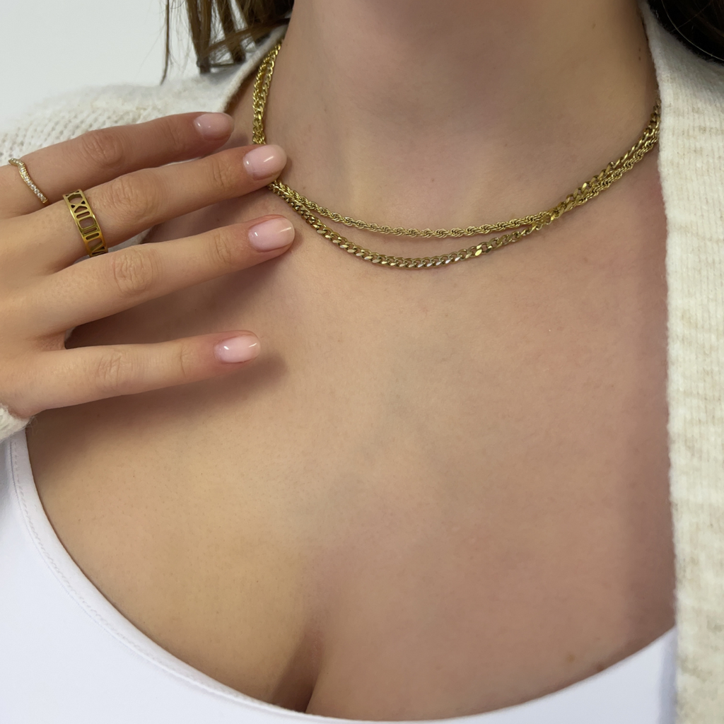 Rope and cuban gold chain layered toegther on a model 